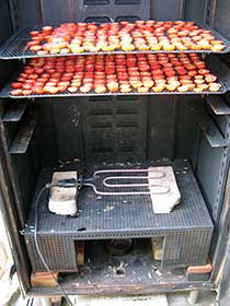 Drying tomatoes in a smokehouse.