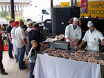 As lady meat technologist discusses a freshly made sausage a young sausager is trying to figure it out.