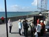 Tourists buying smoked fish.