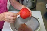 Peeled tomatoes are even easier to seed. Cut them across as described above.