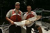 Big Muddy National Wildlife Refuge, Missouri, employees hold an Asian carp.