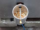 Smoke Daddy smoke generator with wood chips inside.