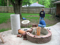 Laying bricks around concrete pipe